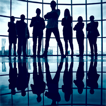 Team silhouettes against office glass