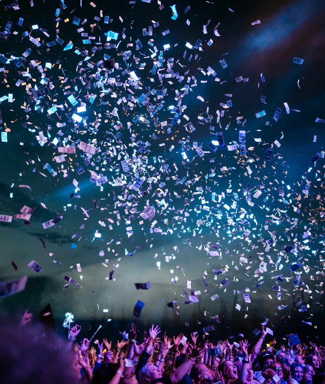Confetti raining over a cheering crowd at a live show